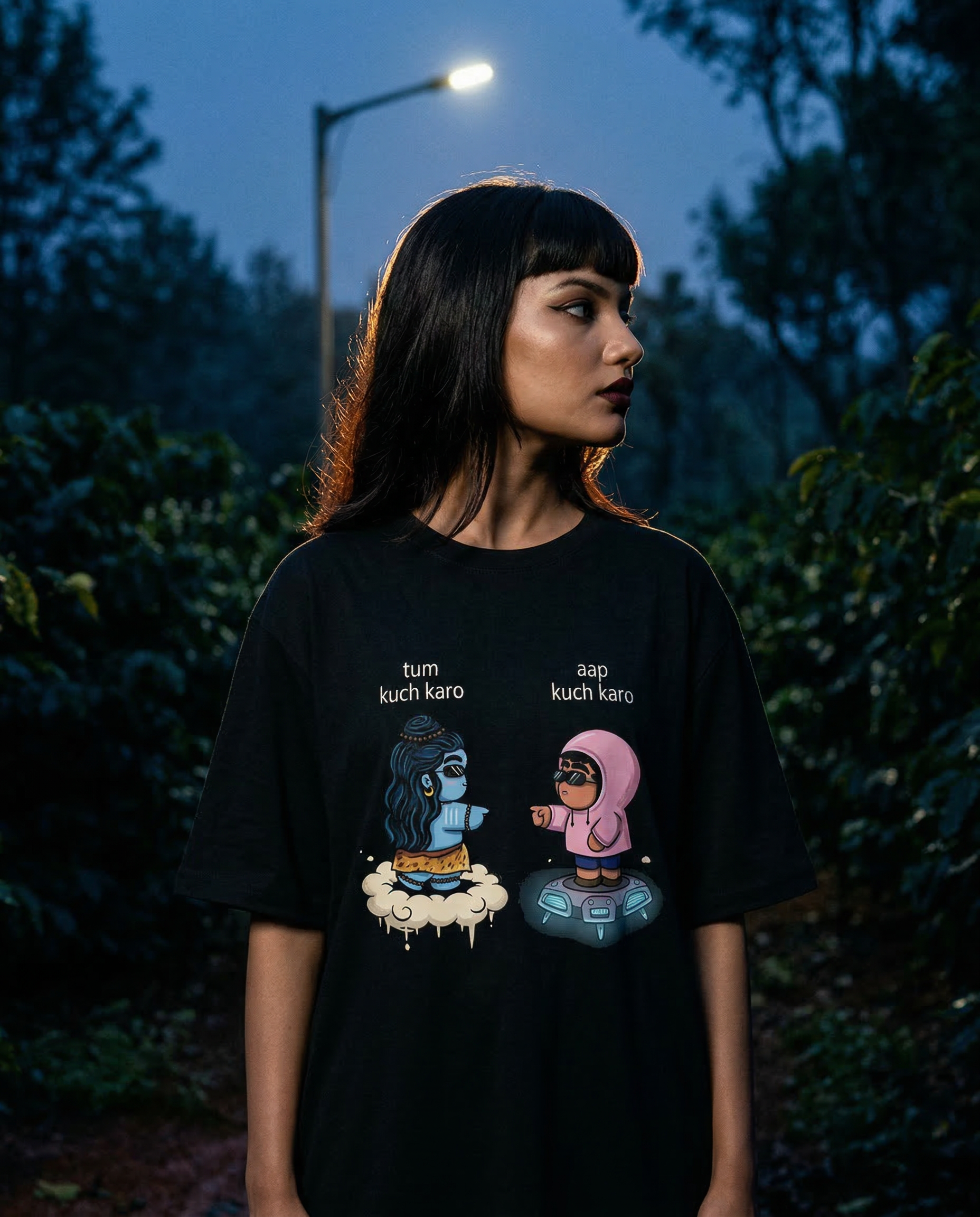 Haunted indie portrait on coffee estate at pre-dawn: oversized tee square to camera, combat boots, one-sided gaze, deep navy silhouette against street lamp and sky.